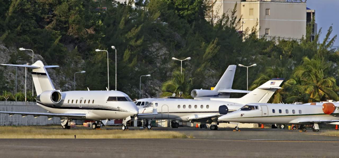 Private business jets parked on the ramp