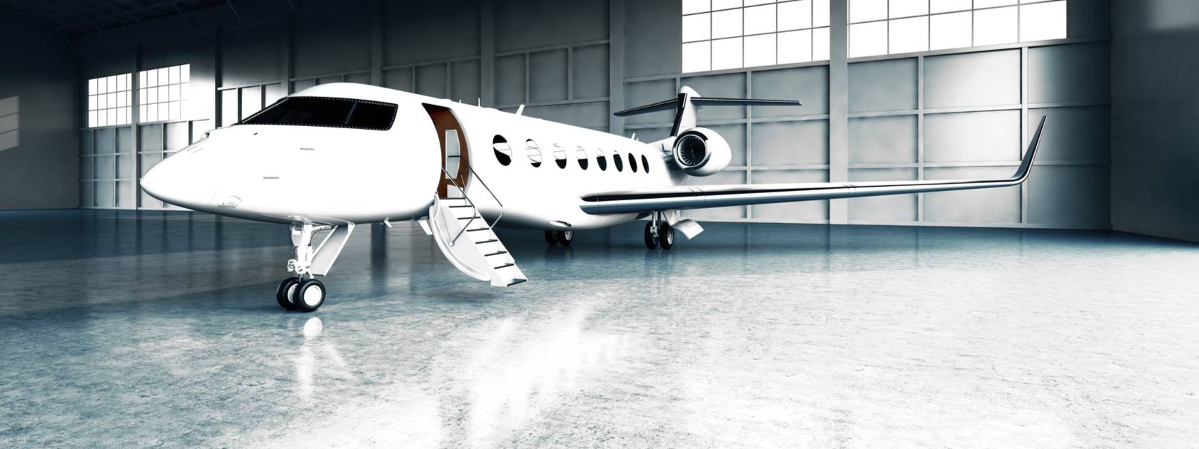white private jet in a hangar