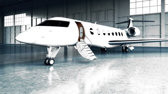 white private jet in a hangar
